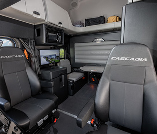 Freightliner Cascadia sleeper cab interior showing dual branded seats and living space amenities